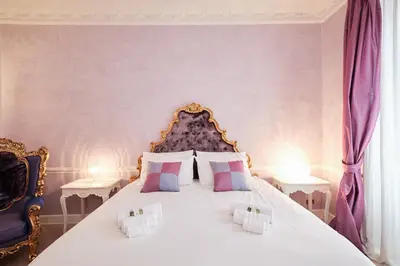 a bedroom with a large white bed with purple walls at Luxury in Piazza di Spagna in Rome