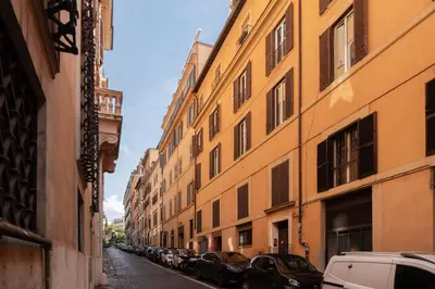 an alley with cars parked on the side of a building at Rasella 21 - FromHometoRome in Rome