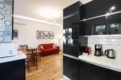 a kitchen and living room with a red couch at Casilina 403 Spacious Apartment 3BDR and 3 BATH in Rome