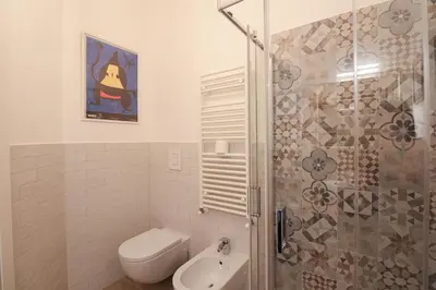a bathroom with a shower and a toilet and a sink at Casilina 403 Spacious Apartment 3BDR and 3 BATH in Rome