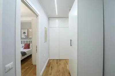 a bedroom with white walls and a door leading to a bed at Casilina 403 Spacious Apartment 3BDR and 3 BATH in Rome