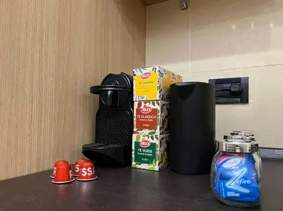 a counter top with a coffee maker and a box of milk at Oasi Floreale - Roma Termini in Rome