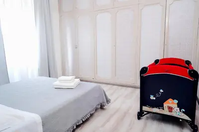 a bedroom with a bed and a red suitcase at Casa Cornelia Station in Rome