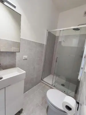 a bathroom with a shower and a toilet and a sink at Casa Cornelia Station in Rome