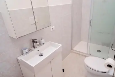 a bathroom with a toilet and a sink and a shower at Casa Cornelia Station in Rome