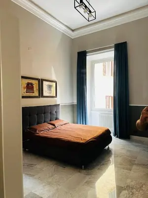 a bedroom with a bed in a room with a window at Via Veneto Luxury Maison in Rome