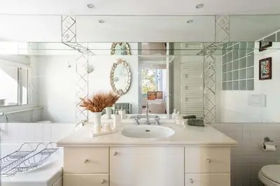 a bathroom with a sink and a mirror at Trastevere - Dolce Vita 4bedr 360 Terrace in Rome
