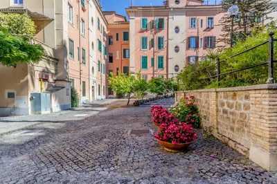 a street in a city with flowers in a basket at Casa Jordan 47 in Rome