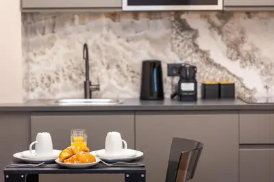 a kitchen with a table with plates of oranges on it at Luxury Suite Trevi in Rome