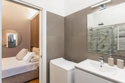 a bathroom with a sink and a toilet and a mirror at Luxury Suite Trevi in Rome