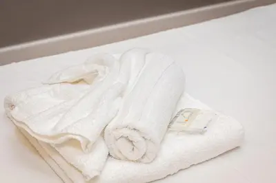 a pile of white towels sitting on a counter at Luxury Suite Trevi in Rome