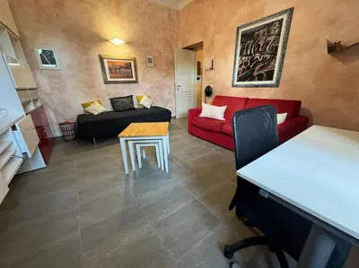 a living room with a red couch and a table at Domus Musei Vaticani Roma Centro 