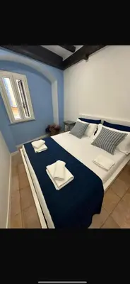 a bedroom with a large bed with blue walls at Casa del Giglio in Rome