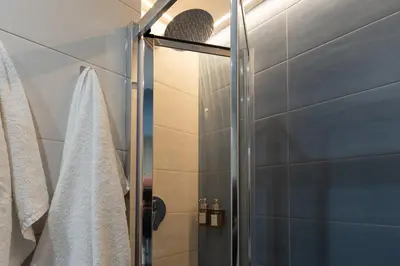 a shower with a glass door in a bathroom at GES House Roma in Rome