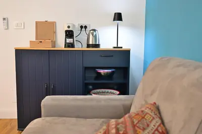 a living room with a couch and a cabinet at At Home Montebello in Rome