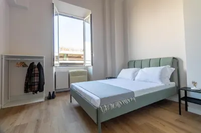 a bedroom with a bed and a window at Joe Litty Rooms in Rome