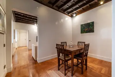 a dining room with a wooden table and chairs at Frezza 39b - FromeHometoRome in Rome