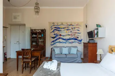 a living room with a bed and a couch at Sales - FromHometoRome in Rome