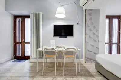 a dining room with a table and two chairs at Barberini - FromHometoRome in Rome