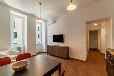 a living room with a table and a tv at Testaccio - FromHometoRome in Rome