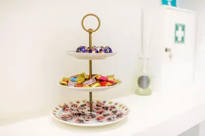 a three tiered display with three plates of candy at Riboty 10 Suites in Rome
