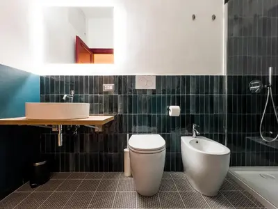 a bathroom with a toilet and a sink and a tub at Tasso Designer Suite - Colosseum Esquilino in Rome