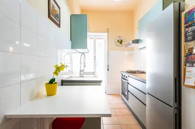 a kitchen with a white counter and a sink at Magiù Apartment in Rome