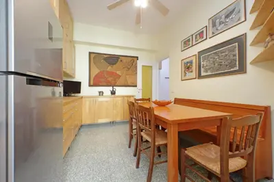 a kitchen with a wooden table and a dining room at Comfy home for family next to Metro in Rome