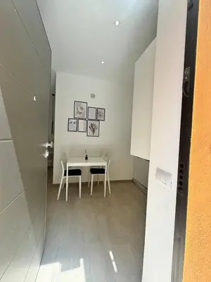 a dining room with a white table and chairs at Little Apartment in Rome