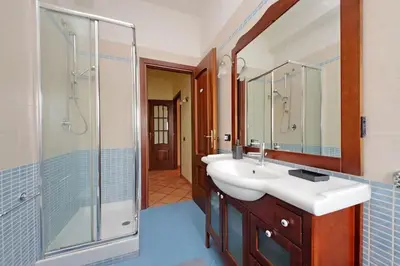 a bathroom with two sinks and a shower at Aria di Roma Appartamento in Rome