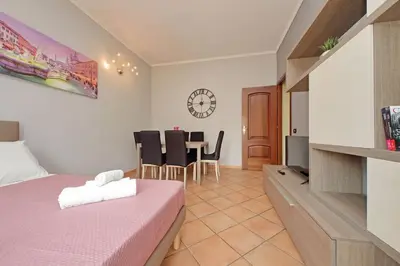 a bedroom with a bed and a table with chairs at Aria di Roma Appartamento in Rome