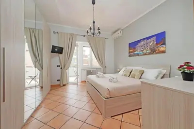 a bedroom with a bed and a table in a room at Aria di Roma Appartamento in Rome