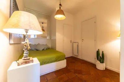 a green bed with a doughnut on top of it at Campo dei Fiori Elite Luxury for 10 guests in Rome