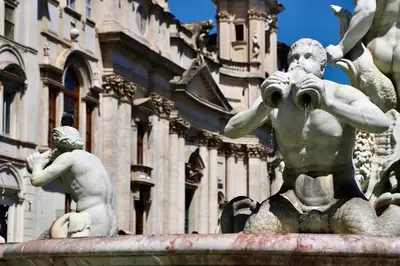 a statue of a fountain in front of a building at Casa Acerbo - Rome Navona Apartment in Rome