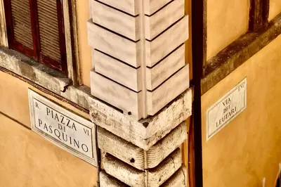 a building with two street signs on the side of it at Casa Acerbo - Rome Navona Apartment in Rome