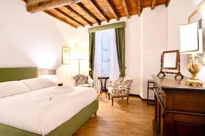 a bedroom with a bed and a desk and a mirror at Casa Acerbo - Rome Navona Apartment in Rome