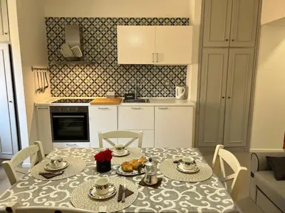 a kitchen with a table and a kitchen with a dining room at Casa dolce Roma Prati in Rome