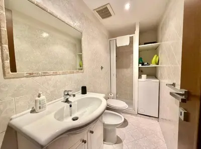 a white bathroom with a sink and a toilet at Casa Flavia in Rome