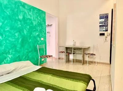 a bedroom with a bed and a table and chairs at Casa Flavia in Rome