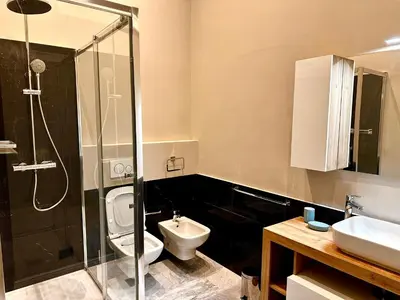 a bathroom with a shower and a toilet and a sink at The Great Maison in Rome