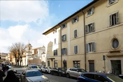 a city street with cars parked in front of buildings at Views of the Coliseum in Rome
