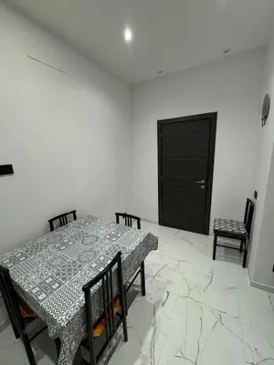 a dining room with a table and chairs and a black door at Heaven of Maya in Rome
