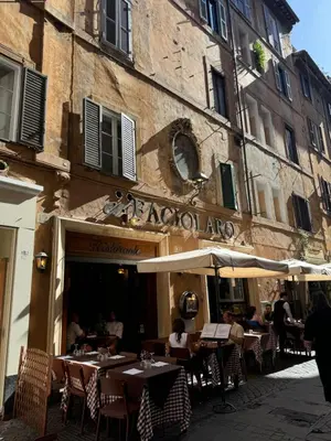 a restaurant with tables and umbrellas in front of a building at Maison Luxury Pantheon in Rome