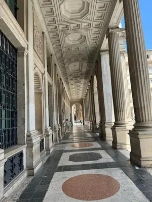 an empty hallway of a building with columns and a ceiling at Maison Luxury Pantheon in Rome