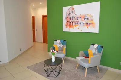 a living room with two chairs and a table at GarbantSuite Apartment In Rome in Rome