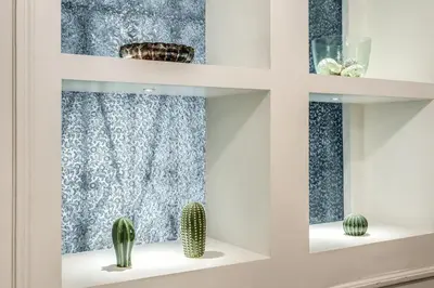 a shelf with cactuses and a window at Nest House Prati in Rome