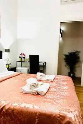 a bedroom with a bed with towels on it at Rome Holiday Guesthouse in Rome
