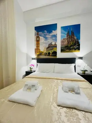 a bedroom with a large bed with two white pillows at Rome Holiday Guesthouse in Rome