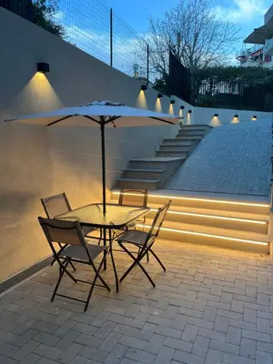 a table and chairs with an umbrella on a patio at Panti Guesthouse in Rome