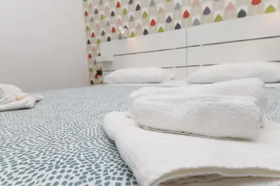 a group of towels sitting on a bed at Giulia's Vatican Apartment Saint Peter in Rome